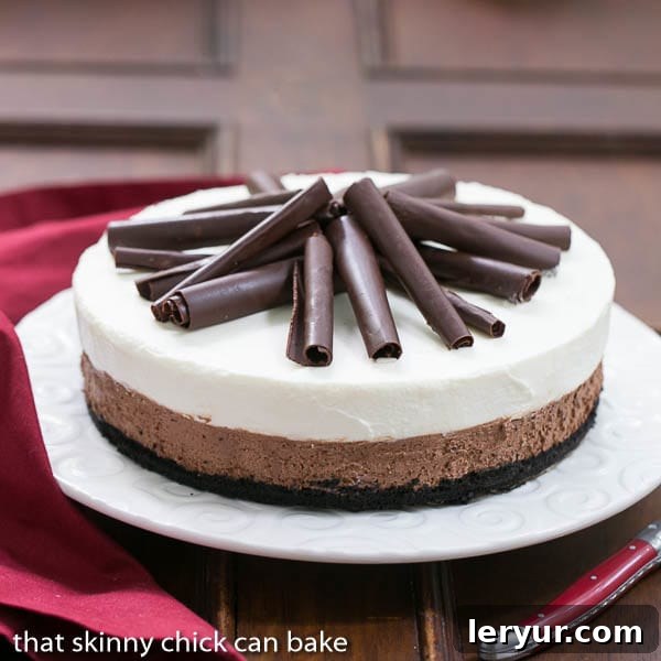 Triple Chocolate Mousse Pie on a serving plate topped with chocolate curls.