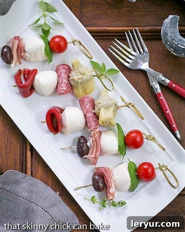Antipasto Skewers arranged neatly on a rectangular white tray.
