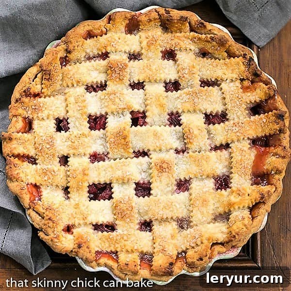 An inviting overhead view of a beautifully baked Classic Rhubarb Pie in a rustic ceramic pie plate, showcasing its golden lattice crust.