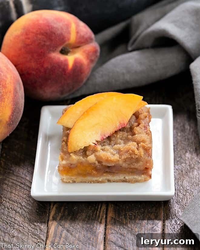 Fresh Peach Pie Bar on a white plate topped with peach slices