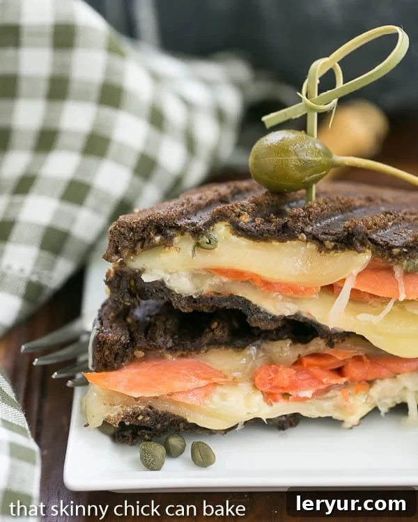 Smoked Salmon Rye Melt 2 Smoked Salmon Reuben. Sandwich | A fabulous seafood twist on the classic sliced in half and stacked on a square white plate.