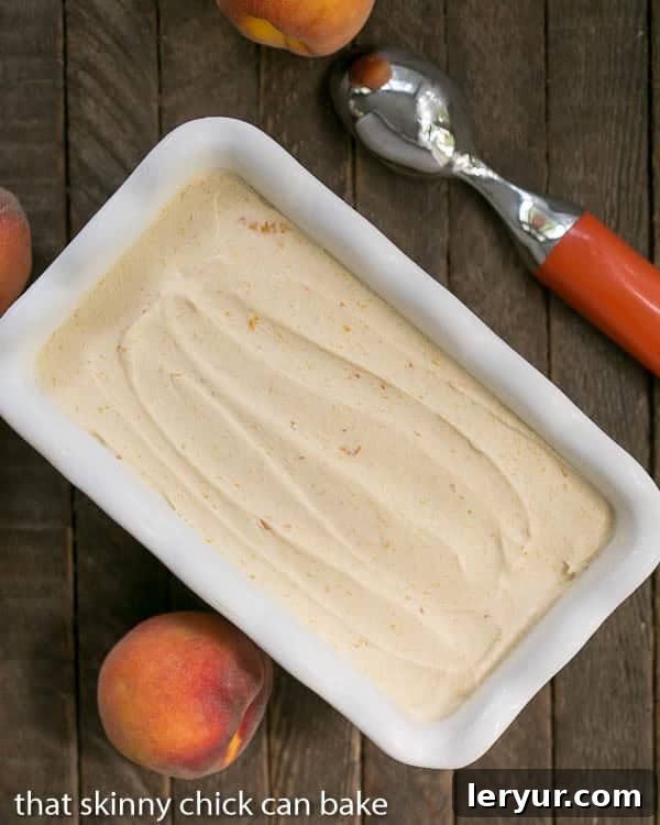 Roasted Peach Ice Cream (No-Churn) 3 No Churn Roasted Peach Ice Cream in a white ceramic loaf pan