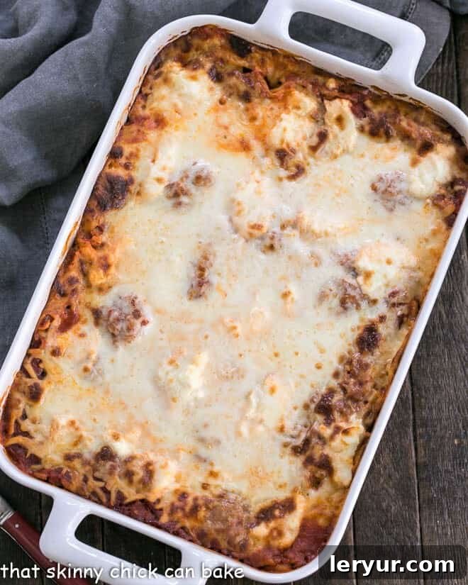 Ricotta Lasagna with Sausage in a white rectangular baking dish, golden brown and bubbling.