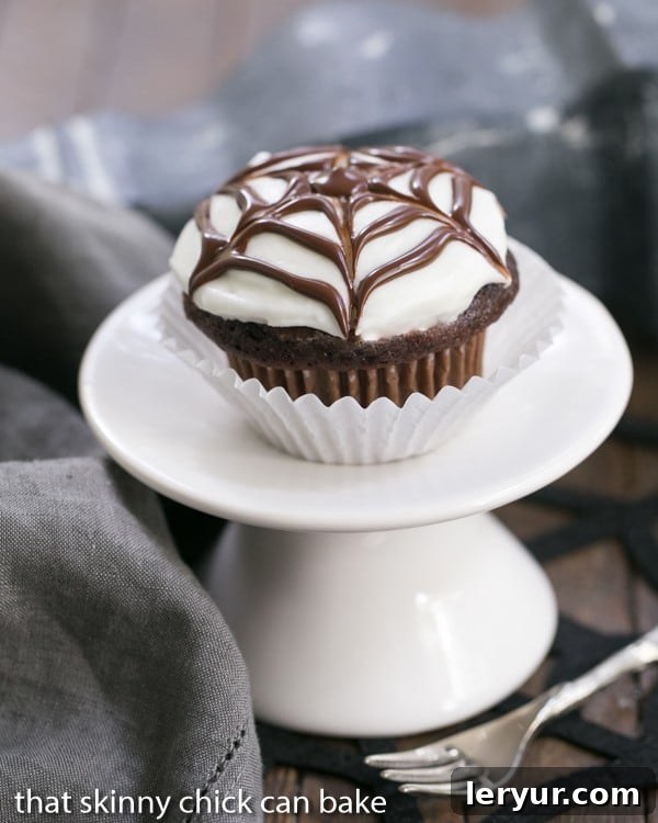 Spiderweb Cupcake on a white pedestal, a perfect Halloween dessert.