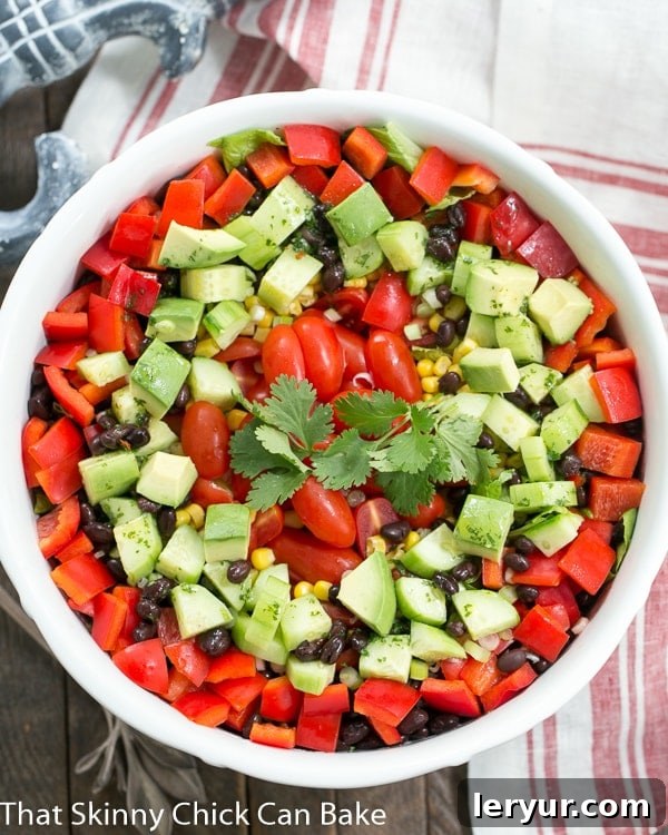 Fiesta Salad - A veggie packed Tex-Mex Salad with a honey lime dressing Overhead view of a Tex-Mex Fiesta Salad in a white salad bowl