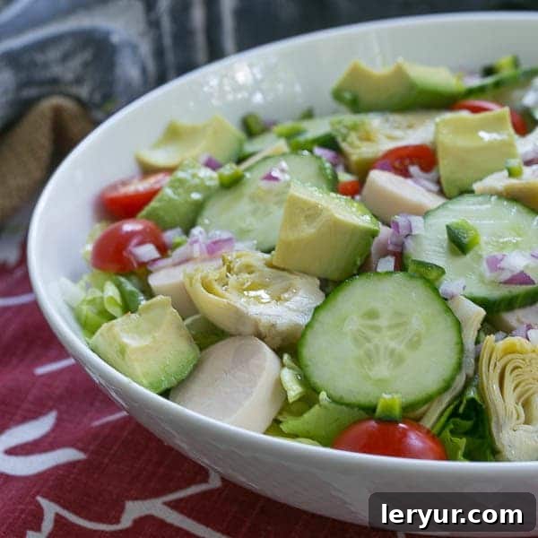 Refreshing, tasty Hearts of Palm, Artichoke, Avocado and Butter Lettuce Salad Hearts of Palm, Artichoke, Avocado and Butter Lettuce Salad in a white serving bowl