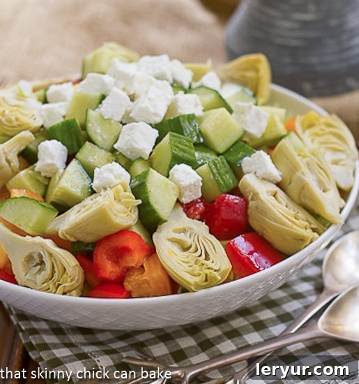 Greek Salad - Full of crisp vegetables and chunks of feta! Greek Salad in a white serving bowl