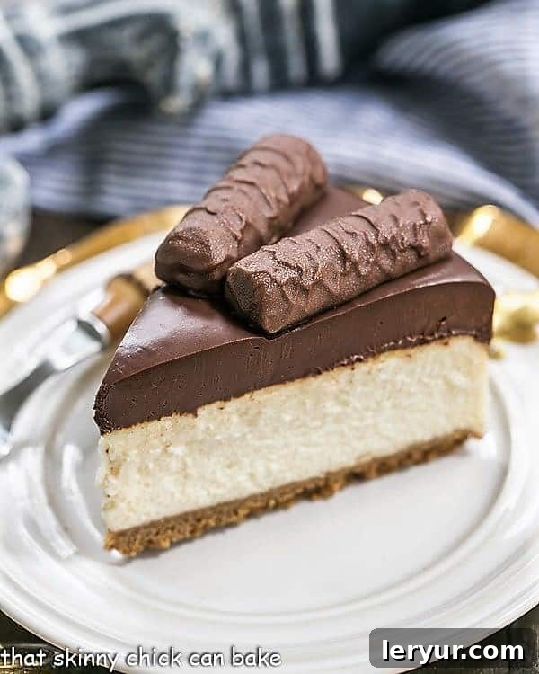 Twix Cheesecake - A dream cheesecake for chocolate and caramel lovers! A perfectly sliced piece of Chocolate Caramel Twix Cheesecake on a white dessert plate, showing its distinct layers.