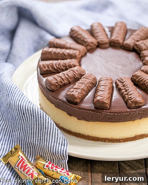 Twix Cheesecake - A dream cheesecake for chocolate and caramel lovers! An assembled Chocolate Caramel Twix Cheesecake, ready for serving, showcasing its beautiful layers.
