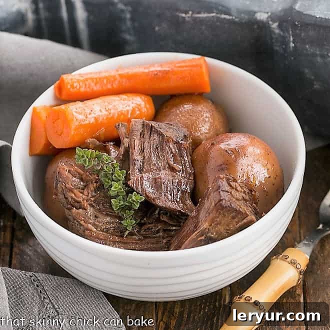 A bowl of rich pressure cooker beef stew with tender chunks of beef, potatoes, and carrots, garnished with fresh parsley.