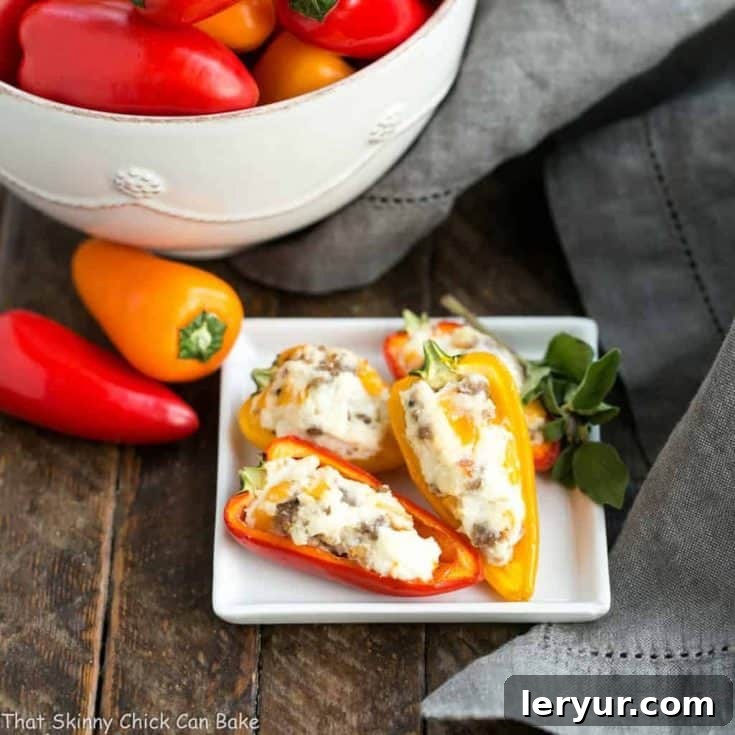 Cream Cheese Stuffed Mini Peppers with Sausage, served on a white platter, showing the vibrant colors of the peppers and the savory filling.