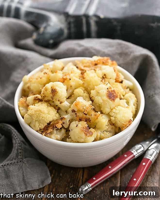 Golden brown roasted cauliflower florets sprinkled with Parmesan cheese and bread crumbs.