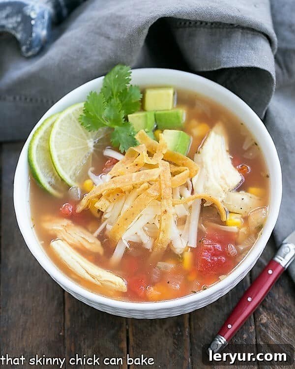 Leftover Turkey Tortilla Soup - A hearty, flavorful soup that utilizes leftover holiday turkey, garnished with fresh toppings! A steaming bowl of Leftover Turkey Tortilla Soup, garnished with fresh cilantro and lime, ready to be enjoyed.