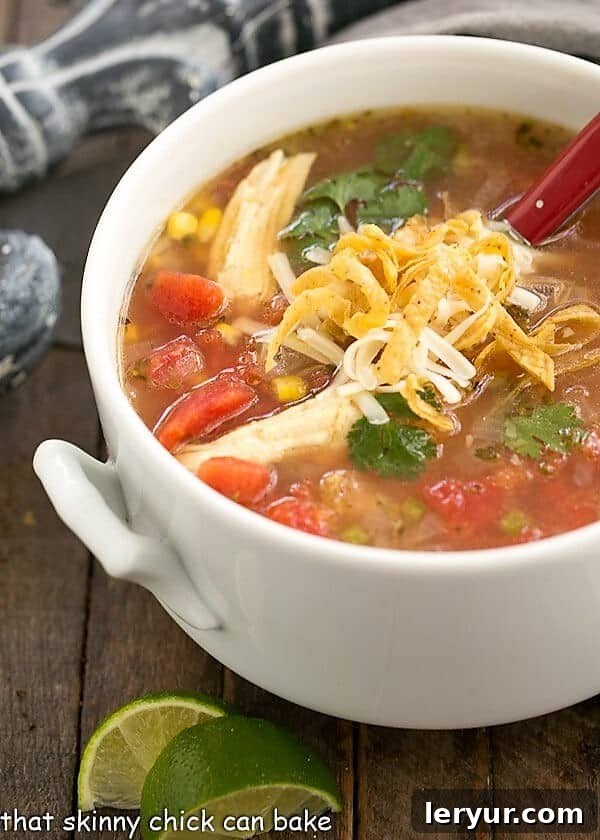Leftover Turkey Tortilla Soup - A delicious and easy way to enjoy turkey leftovers! A white terrine filled with Leftover Turkey Tortilla Soup, ready for serving.
