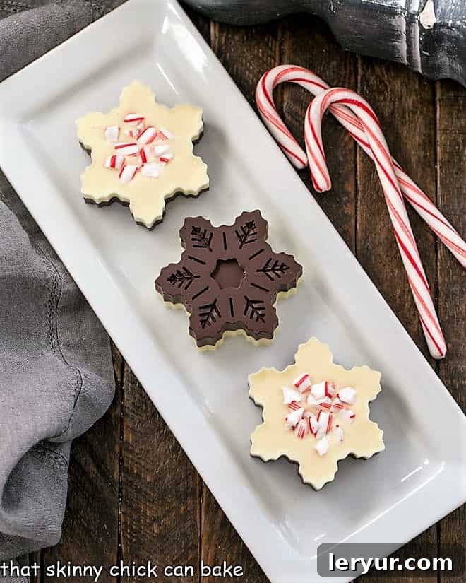 An overhead view showcasing the front and back of layered peppermint bark snowflakes, revealing their crisp, clean edges and perfectly defined chocolate layers.