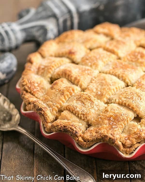 Deep Dish Apple Pie - Packed full of precooked apples makes for a perfect autumnal pie! Deep Dish Apple Pie with a lattice crust in a red ceramic pie plate.