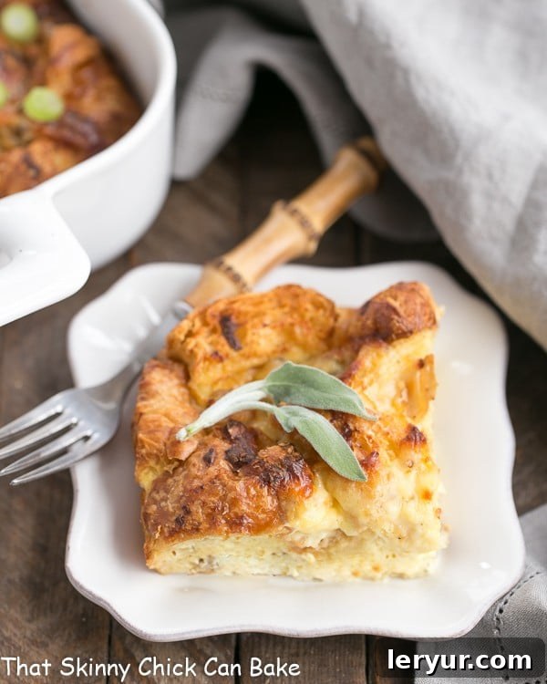 Sausage Croissant French Toast Casserole - Tender, buttery and full of flavor from sausage, herbs and Gruyere, perfect for brunch or holidays Sausage Croissant French Toast Casserole serving on a small white plate, garnished with fresh herbs.