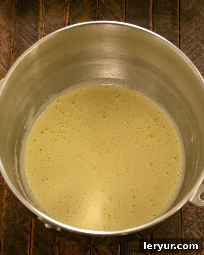 Beating eggs, granulated sugar, and vanilla extract until light and fluffy in a large mixing bowl, then adding mayonnaise.