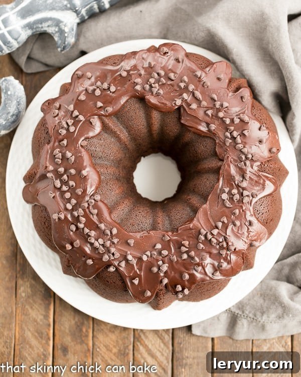 An overhead view of the finished Cheesecake Stuffed Chocolate Bundt Cake, generously drizzled with chocolate ganache.