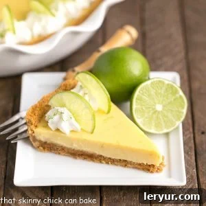 Classic Key Lime Pie with a citrus filling nestled in a graham cracker crust, garnished with lime slices.