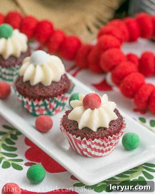Close-up of frosted Mini Red Velvet Cupcakes on a white tray, showcasing their perfect size and rich red color.