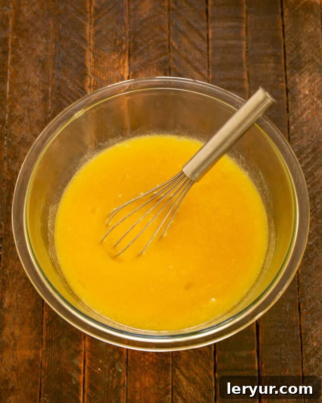 Irresistible Peanut Butter Truffle Brownies 4 Melted butter in a bowl with sugar, eggs, and vanilla ready to be mixed.