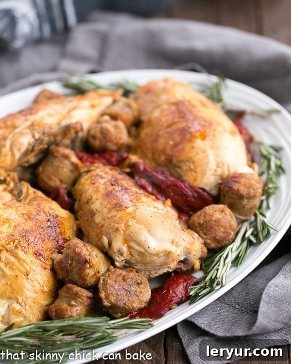 Chicken Scarpariello with Sausage on a platter garnished with fresh rosemary.