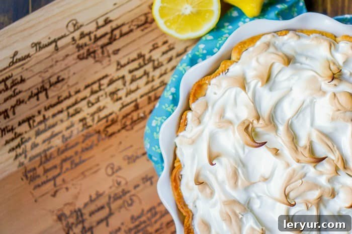 A classic lemon meringue pie with a golden, peaked meringue topping.