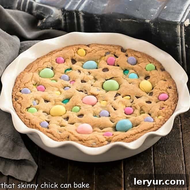 A festive Easter cookie cake decorated with colorful candies and chocolate chips.