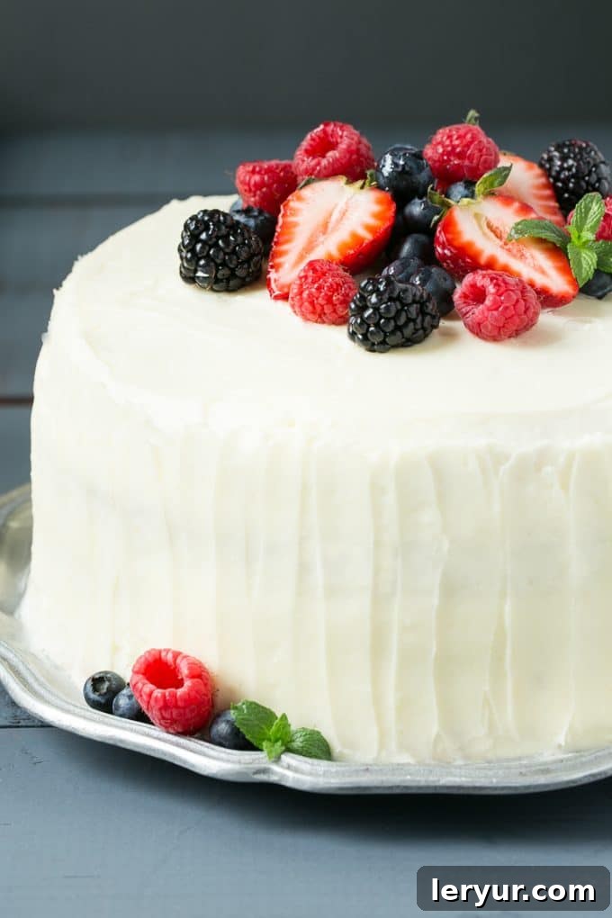 A beautifully decorated berry chantilly cake with fresh berries.