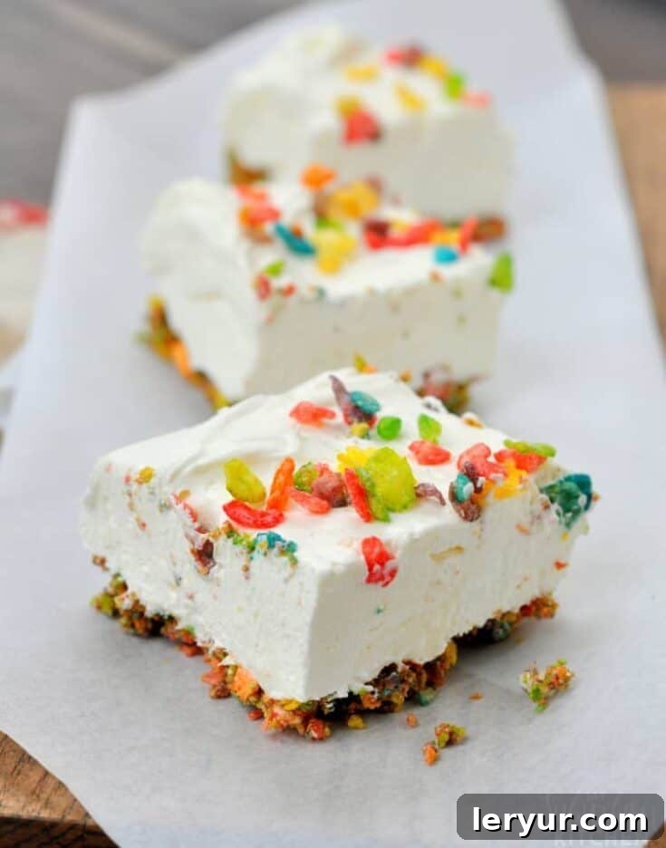 Colorful Fruity Pebbles No Bake Cheesecake Bars, a festive dessert.