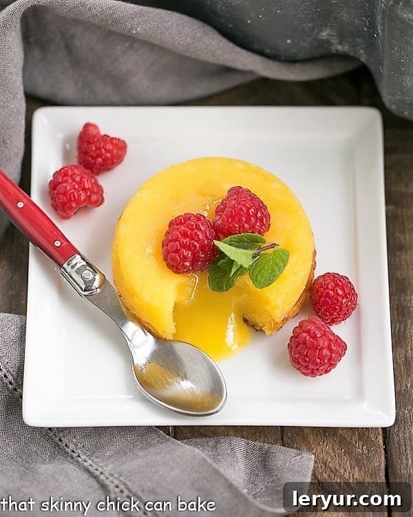 White Chocolate Molten Lava Cakes - Dreamy individual white chocolate cakes with molten centers! A close-up view of a White Chocolate Molten Lava Cake on a square, white ceramic plate, showcasing its rich, creamy texture and perfect presentation.