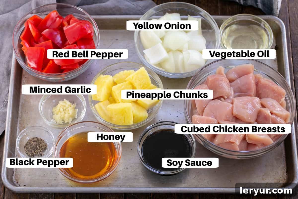 Sweet and Sticky Honey Chicken Kabobs 2 Various Chicken Kabob Ingredients laid out on a metal sheet pan, clearly labeled for preparation.