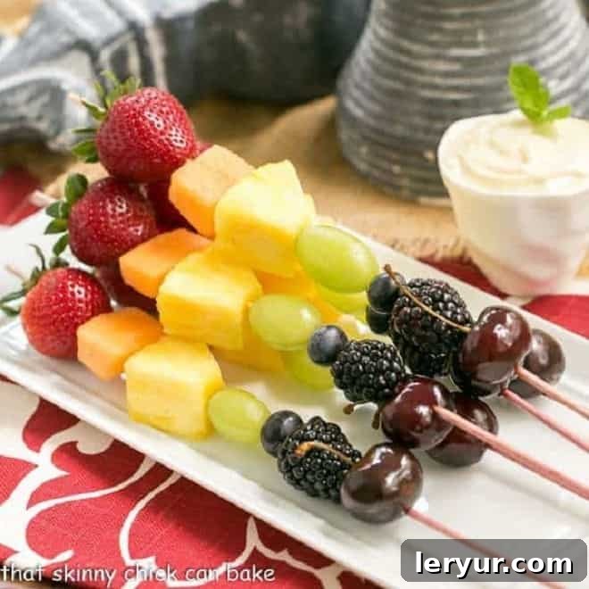 Rainbow fruit kebabs served with a delicious white chocolate mascarpone dip for a healthier dessert.