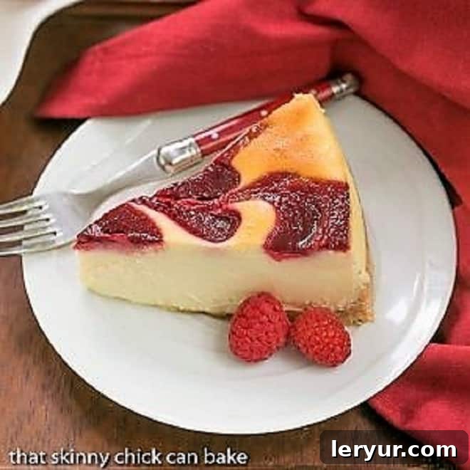Elegant white chocolate cheesecake with a beautiful raspberry swirl.