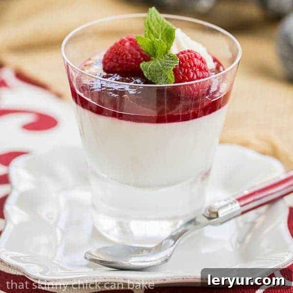 Layered dessert with raspberries, white chocolate, and cheesecake flavors in a parfait.