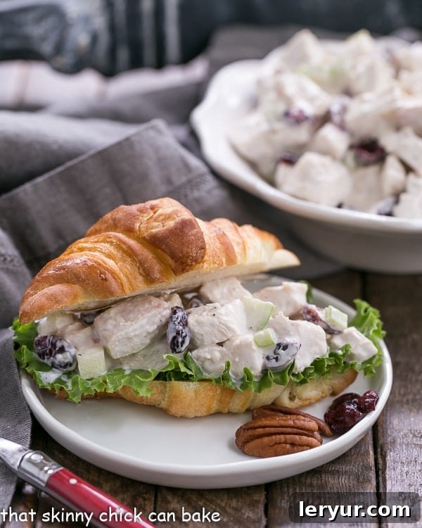 Cranberry Pecan Chicken Salad for a Crowd - Perfect for showers, luncheons and more! Cranberry Pecan Chicken Salad artfully arranged on a mini croissant, ready for serving.