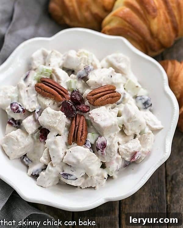 Chicken Salad Sandwich Recipe - Perfect for showers, luncheons and more! Large bowl of Cranberry Pecan Chicken Salad, generously filled and ready for serving at a gathering.