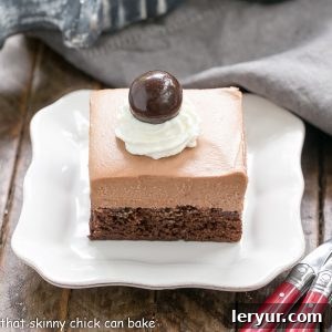 A full tray of perfectly cut French Silk Pie Brownies, ready to be served, highlighting their layers and chocolate curl garnish.