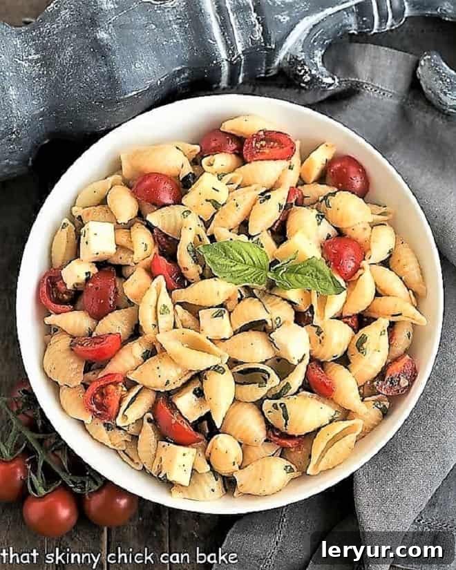 Tomato Basil Pasta Salad with Mozzarella & Fontina, a fresh pasta salad with ripe tomatoes, fragrant basil, and two types of cheese.