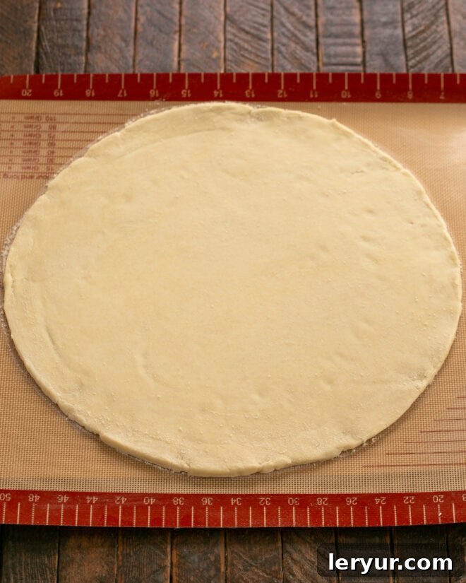 Apple Galette crust expertly rolled out into a perfect round on a Silpat baking mat, demonstrating readiness for filling.