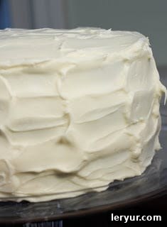 A close up of a red velvet cake frosting