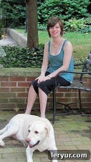 A girl sitting on a bench with a dog