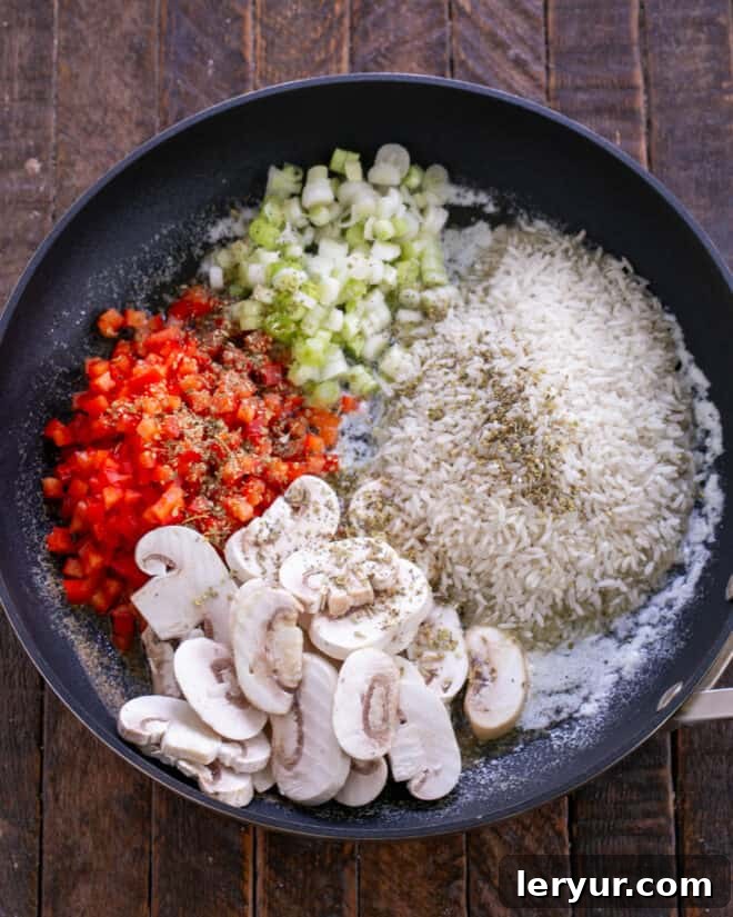 Rice, mushrooms, bell peppers, onions, and seasoning added to melted butter in a skillet.