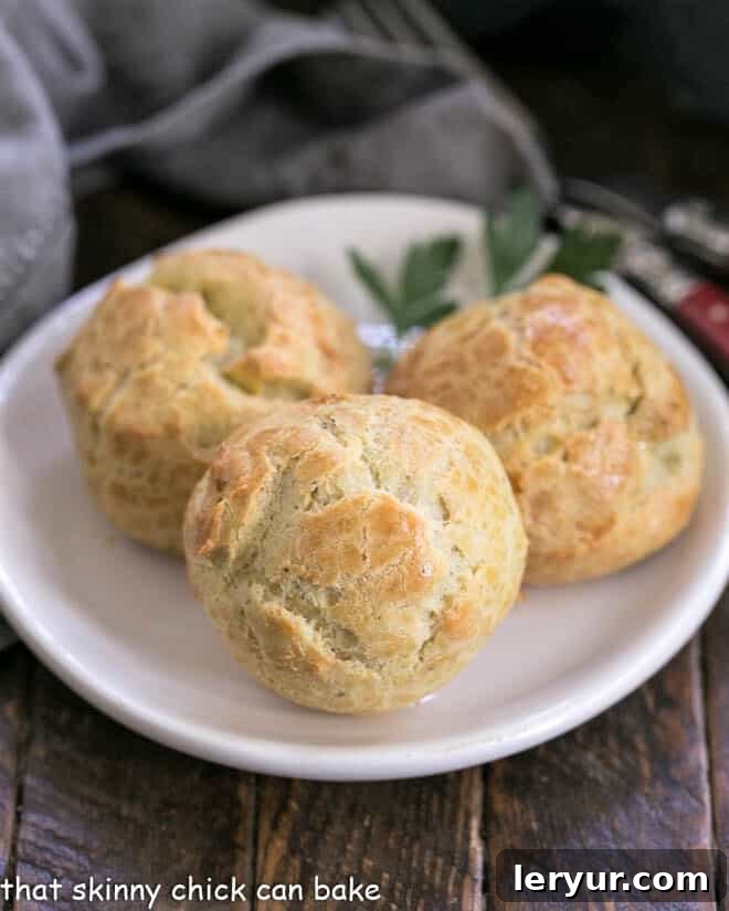 Blue Cheese Gougères - a twist on the classic pâte à choux pastry based cheese puffs with blue cheese and a pinch of cayenne! Absolutely irresistible! Blue Cheese Gougères artfully arranged on a small white plate for an elegant appetizer presentation.