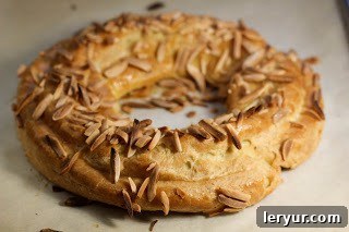 A close-up view of a freshly baked Paris-Brest pastry, golden and perfectly puffed