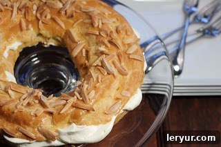 A close-up shot of a Paris-Brest pastry expertly filled with creamy goodness, ready to be sliced