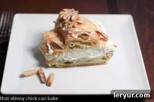 Another enticing view of a delicious Paris-Brest, generously dusted with confectioners sugar