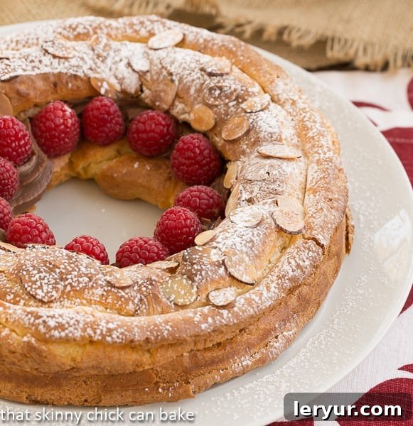A beautifully assembled Paris-Brest dessert, dusted with confectioners sugar and ready to serve