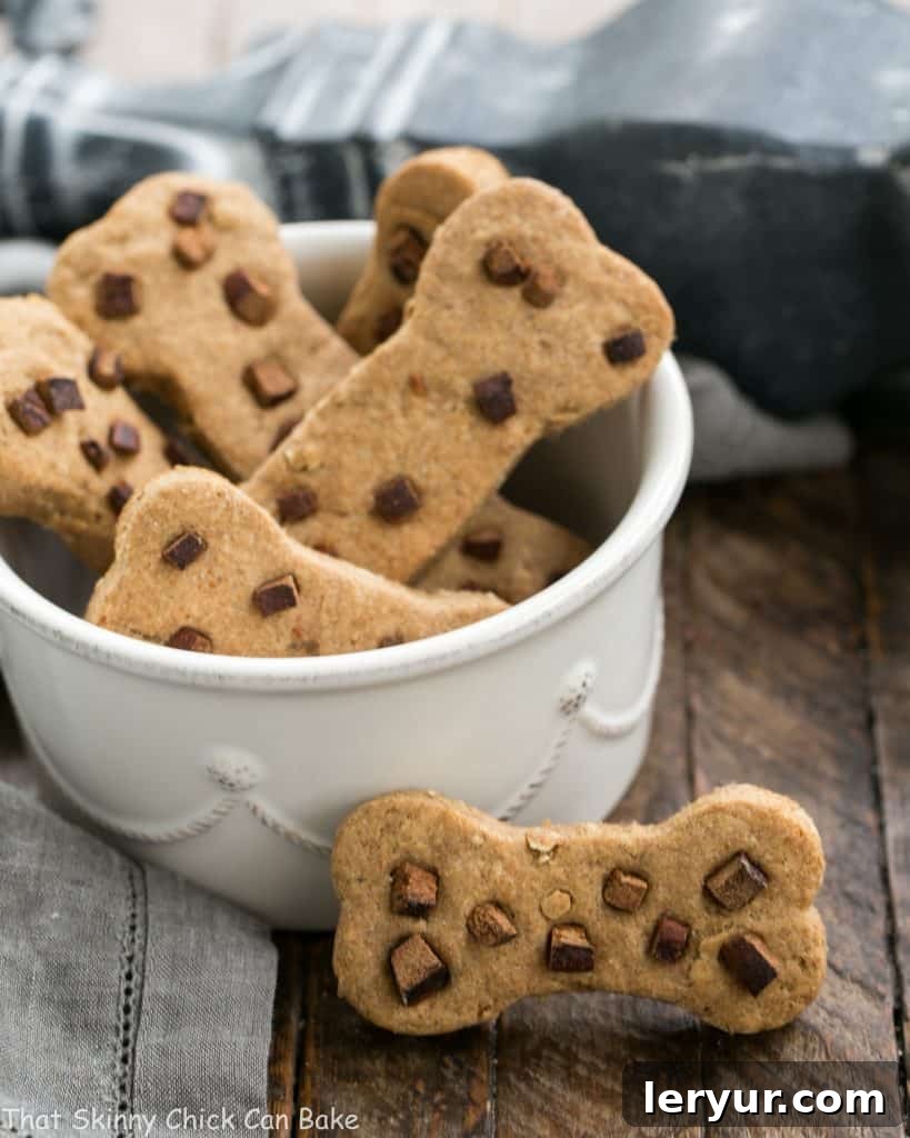 A delectable stack of homemade peanut butter dog bone treats, artfully arranged, promising a delightful and healthy snack for any dog.